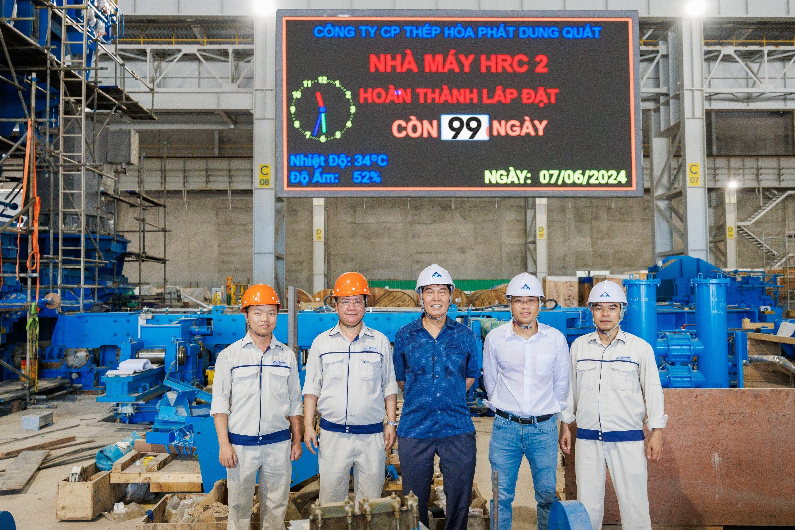  Chủ tịch Trần Đình Long chụp ảnh cùng BGĐ Công ty, BGĐ Nhà máy QSP và Trưởng Ban Dự án Hòa Phát Dung Quất 2 tại bảng đếm ngược Nhà máy HRC 2 hoàn thành lắp đặt còn 99 ngày